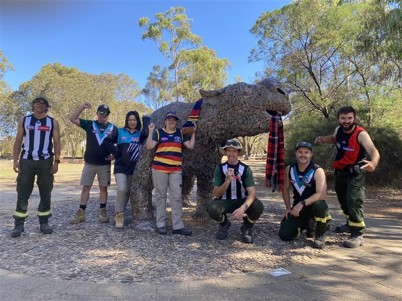 The team and Naracoorte embracing the footy spirit alongside the diprotodon at Naracoorte Caves.