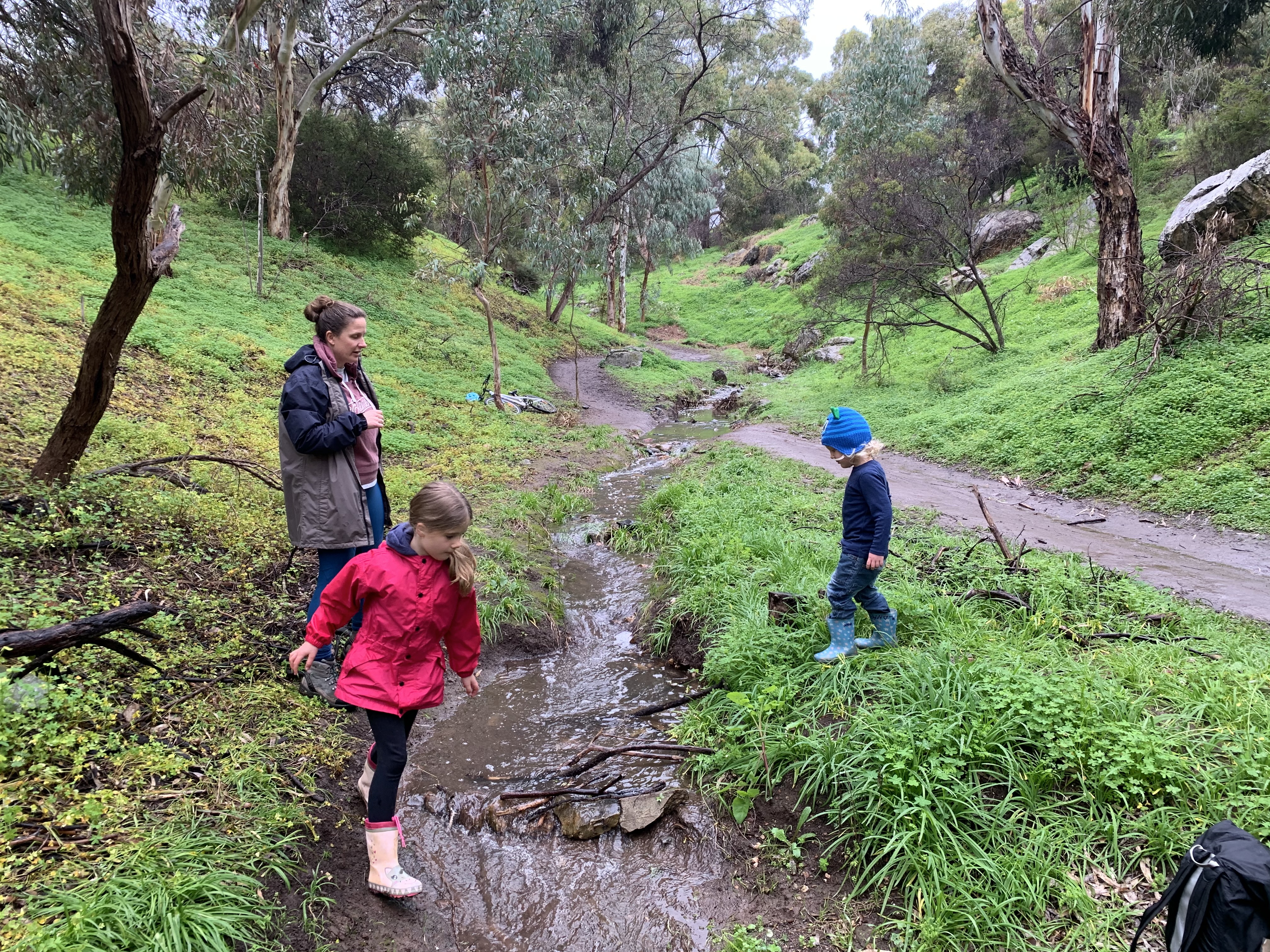 Emma and her kids playing in nature.