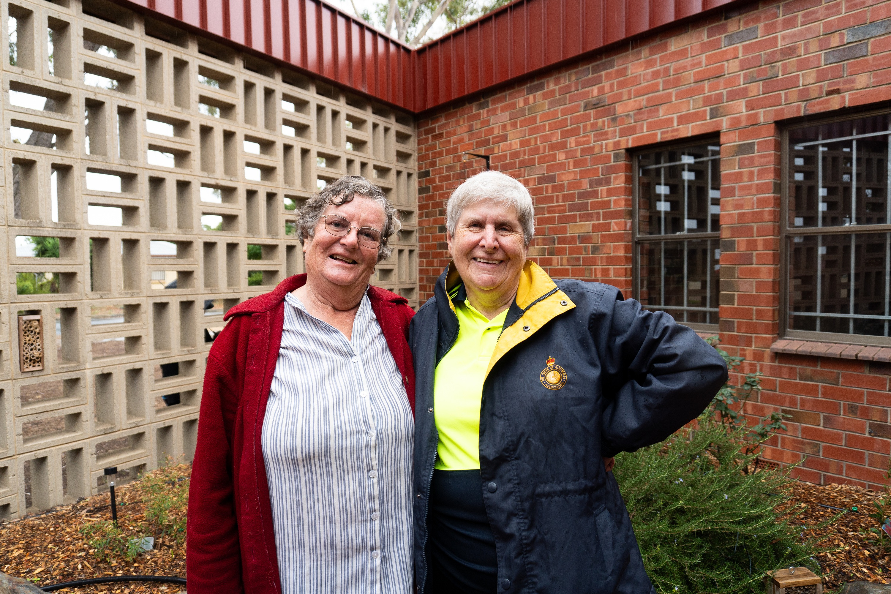 Two ladies standing in front of a memorial garden.