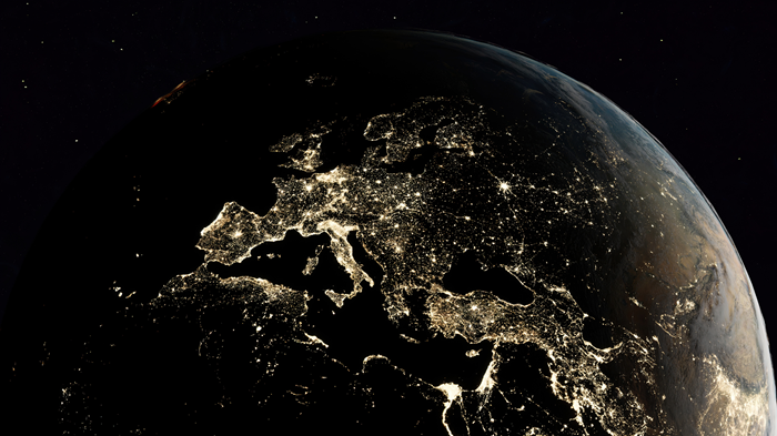 night time view of part of the world from space lit by artificial lights